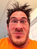 closed_mouth edit glasses irl looking_at_you markiplier neutral orange_shirt photo stubble subvariant:neutralplier variant:markiplier_soyjak // 400x533 // 323.9KB