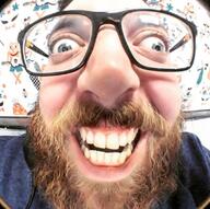 beard blue_eyes brown_beard clothes glasses half_open_mouth irl irl_soy meta:variant_origin series:irl_soyjaks variant:israeli_soyjak // 800x795 // 113.5KB