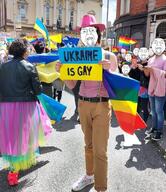 clothes flag flag:lgbt_pride_flag flag:ukraine gay glasses hat lgbt multiple_soyjaks open_mouth pride_parade shoe soyjak stubble text ukraine ukraine_yes ukrainian_flag variant:bernd // 846x980 // 1.3MB