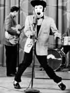 clothes drum ear elvis full_body guitar hair microphone music open_mouth pompadour side_burns singing soyjak variant:kuzjak // 1200x1600 // 2.3MB