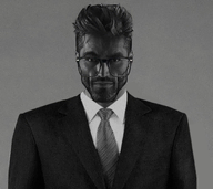 beard clothes collared_shirt front_facing glasses gray_skin hair nas:gigachad serious smart subnas:jager suit suit_and_tie