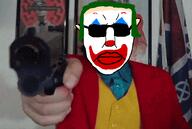 blacksun clothes clown clown_nose flag:confederate_states_of_america glasses green_hair gun gypsy_crusader joker_(2019) joker_(dc) mexicaryan neonazi paul_miller pistol subvariant:pol_face suit sunglasses variant:chudjak // 1499x1010 // 1.8MB