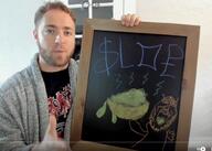 arm bathrobe_dwane chalkboard glasses hand irl oekaki open_mouth soyjak streamer stubble text variant:markiplier_soyjak youtube // 995x708 // 123.3KB