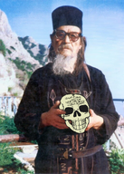 beard belt black_clothing clothes cross death_to_the_world glasses grey_hair hat holding_object irl irl_background long_beard long_hair monk mountain no_glasses no_stubble old orthodox orthodox_christian orthodox_church orthodox_cross orthodoxy outside photo robe skeleton skull sky text variant:feraljak what_you_are_i_once_was_what_i_am_you_will_surely_become white_skin // 800x1125 // 1.2MB