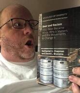 beer book clothes glasses hand holding_book holding_object irl open_mouth racism soyboy soyjak stubble variant:book_soyjak white_skin // 460x535 // 37.7KB