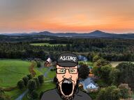ascence_(user) beard cap clothes glasses green_eyes grey_shirt hat irl irl_background mustache open_mouth quebec soyjak text variant:markiplier_soyjak white_skin // 975x730 // 184.1KB