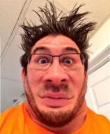 closed_mouth clothes glasses hair irl markiplier mustache orange_shirt smile stubble variant:markiplier_soyjak // 400x487 // 303.1KB