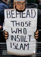 angry beard brown_skin closed_mouth clothes ear glasses hand hat holding_object holding_sign irl_background islam muslims mustache sign soyjak subvariant:duzjak taqiyah text variant:soyak // 252x345 // 136.3KB