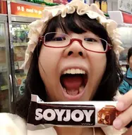 chocolate female glasses hair irl japanese_text looking_at_you meta:not_oc meta:variant_origin open_mouth series:irl_soyjaks soyjoy text variant:joyjak woman // 539x553 // 68.0KB