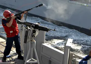 US_Navy_090107-N-3392P-065_Gunner's_Mate_Seaman_James_Clarke_fires_a_shot_line_to_the_Military_Sealift_Command_dry_cargo-ammunition_ship_USNS_Lewis_and_Clark_(T-AKE_1).jpg