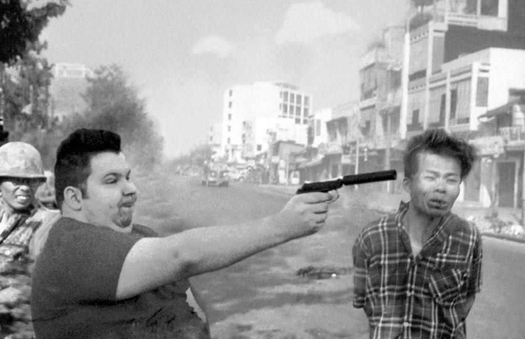 nikocado avocado, soykio kid, irl soyjaks, 'cado, chink, city, gray background, gun, holding gun, holding object