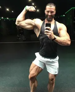 gigachad, buff, clothes, gym, holding object, holding phone, irl background, muscles, muscular male, phone