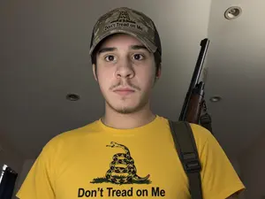 animal, based, brown eyes, brown hair, camouflage, cap, capitalism, closed mouth, clothes, dont tread on me