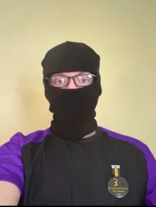 nate higgers, natejak, irl soyjaks, real mascots, 'ki, 1 year on bald men with glasses website, balaclava, cosplay, front view, irl background
