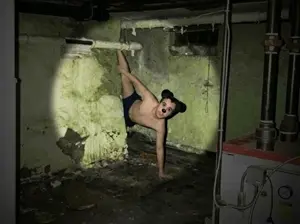 mickey mouse, almost full body, basement, black shorts, dirty room, green walls, pipes, real background, white skin, mickey mouse