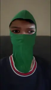 balaclava, brown hair, brown skin, clothes, face mask, front view, hair, irl background, jakarta, lazy eye